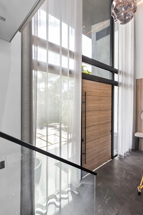 full-height sheer curtains at entry glass, Bal Harbour