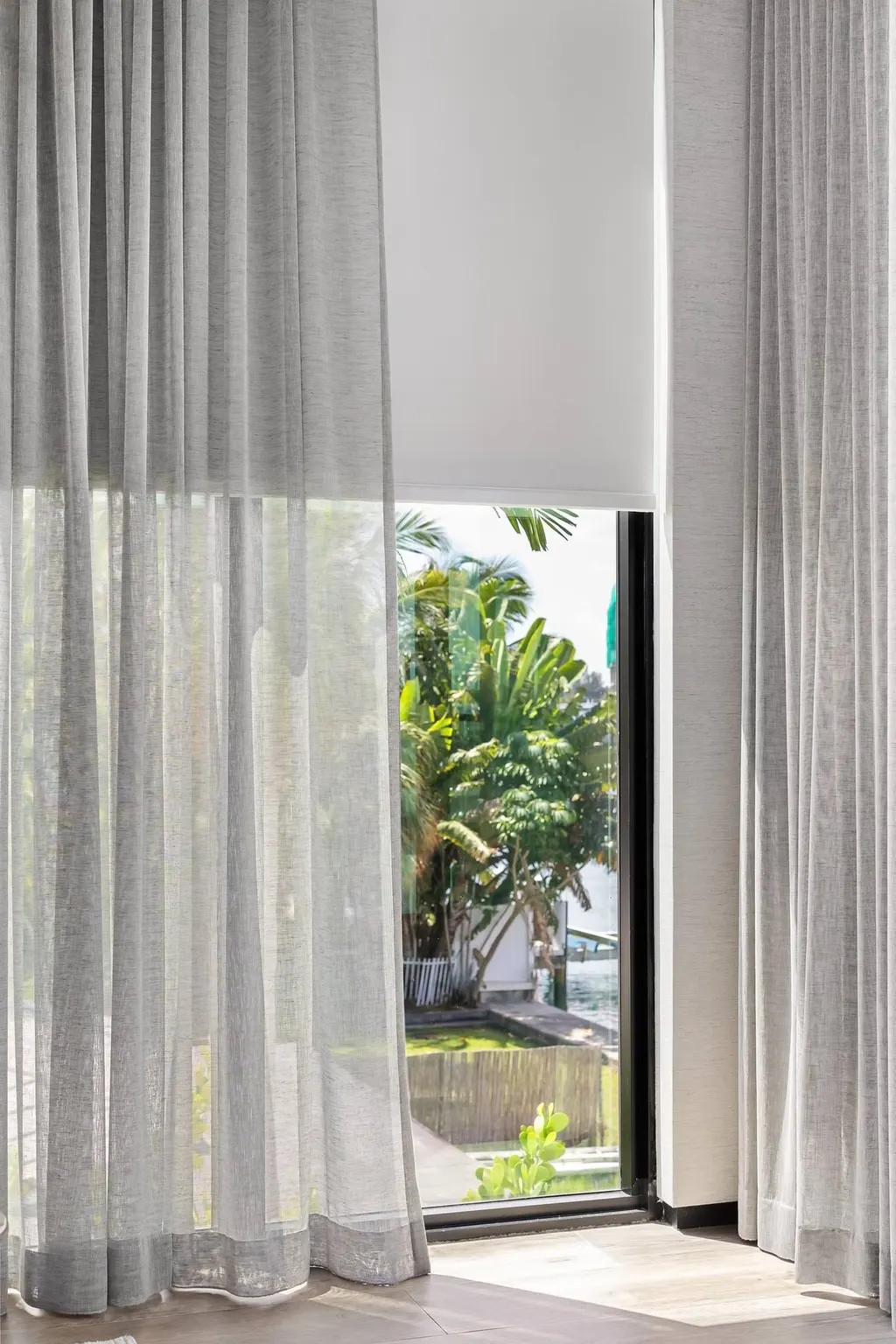 sheer curtains layered over roller shade in bedroom, Bal Harbour